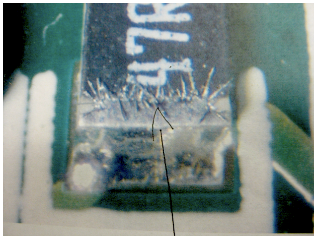 Optical image of silver sulfide corrosion crystals on an electronic component termination